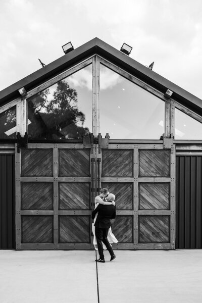 Bride and groom walking through the rain in New Acton Canberra. Outside Parlour.