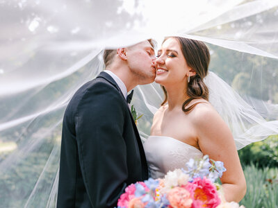 Closeup of bride and groom holding champagne and bouquet during floral garden party inspired wedding at  Basilica St Josaphat Milwaukee
