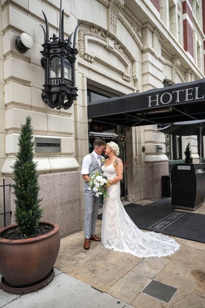 a bride and groom in front on a Denver, Colorado hotel