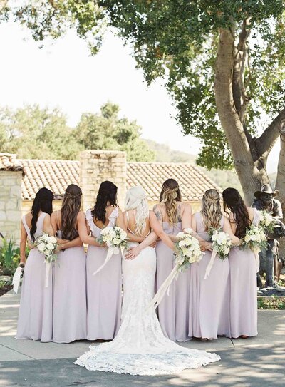 Bride and bridesmaids sharing a joyful moment at Holman Ranch in Carmel, captured by a Napa and San Francisco wedding photographer