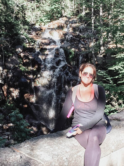 Alison Seponara sitting on a boulder