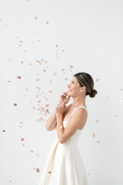 Event planner smiles while looking at confetti falling