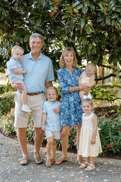 Grandparents smile with their 4 grandchildren