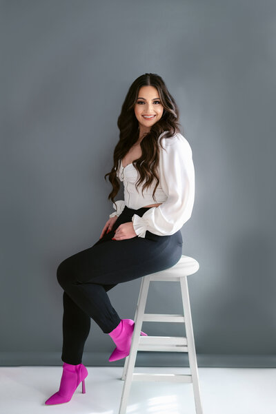 Author studio photoshoot greay, white, black with pop of pink