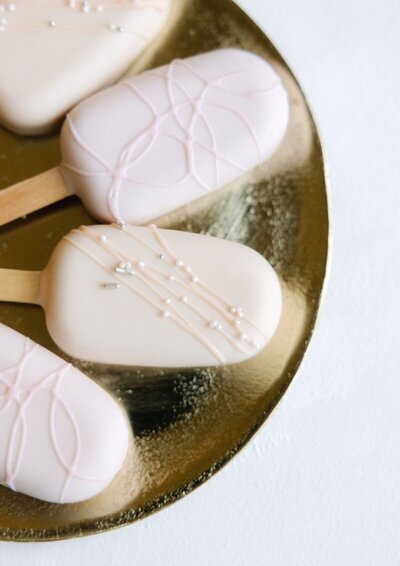 Cake sicles in blush and cream white designed by Eclat Destination Weddings for a destination wedding at Lake Como