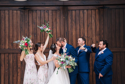 Couple celebrates after being married with a kiss at Cypress Creek Farmhouse Orlando Wedding Venue.