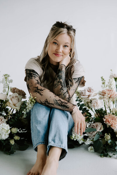 Lauren smiling and holding onto her hat during a cute headshot session.