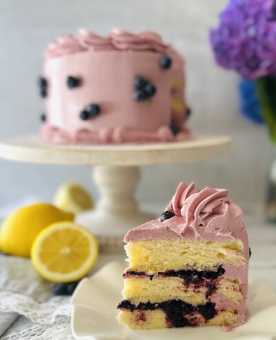 a lemon cake with blueberry filling in between the layers