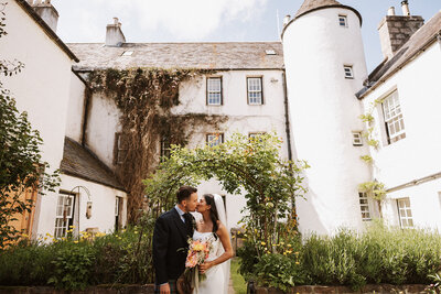 Bride and bridesmaids laughing under confetti at aswanley wedding venue