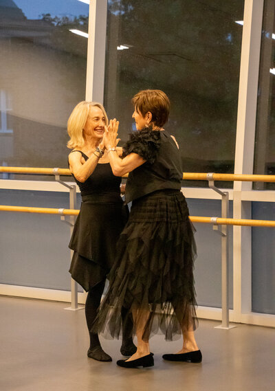 Pair of woman learning to dance in Curtsy Ballroom