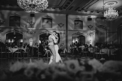 black and white image of couple dancing at wedding reception