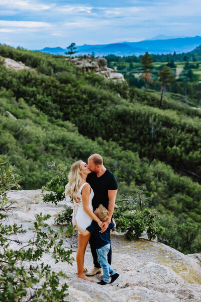 A family of three hug each other out at Daniels Park in Colorado.