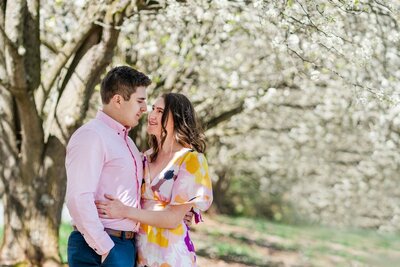 Engagement Session in Charlotte North Carolina. Carlie and Tevon pose underneath gorgeous bradford pear trees in full bloom.
