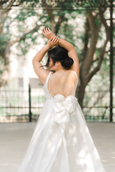 Wedding dress with big bow. Modeling bride pose.