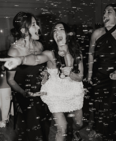 Bride, mother of the bride and sister dancing and singing karaoke together