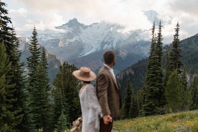 Happy elopement couple with Mount Rainier and a forest as a backdrop