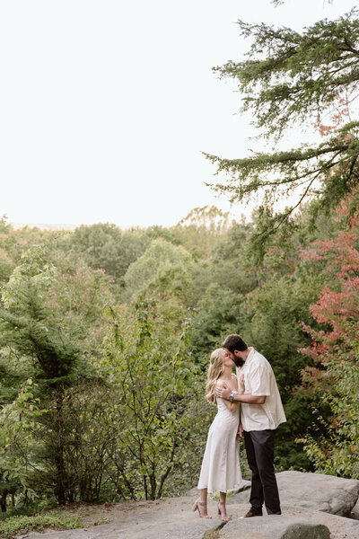 Couple kissing on the overlook at Ledges.