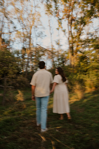 Romantic Omaha engagement session during the fall, captured by Tori Nichole Photography. The couple is surrounded by vibrant autumn foliage and golden light, creating warm, timeless moments. A perfect blend of natural beauty and authentic connection, showcasing the magic of the season and their love story.