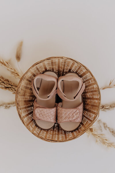 A newborn sleeping with his mouth open and his hand resting on his chin for a newborn family  portraits by San Antonio photographer.