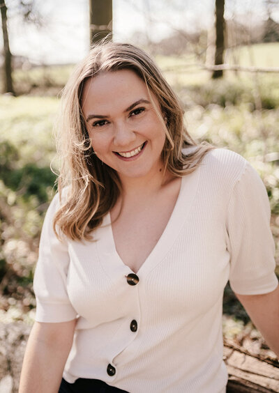 Woman sat enjoying sun in woods