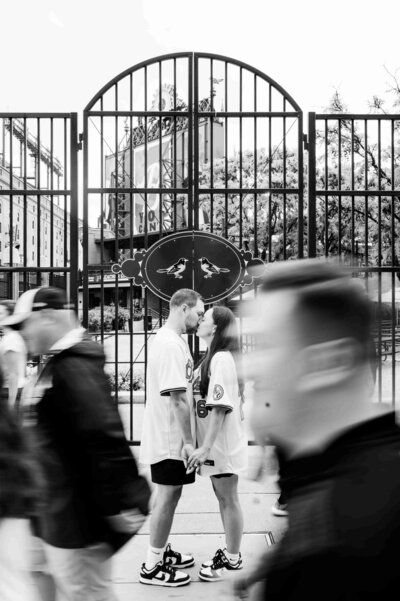 Floral ties, one green and one pink, are styled alongside small flower arrangements and a dish holding two rings, on a light pink background. Elegant and romantic.