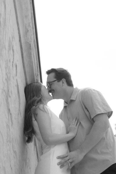Couple standing on the steps of Nuremberg Palace, Germany kissing.