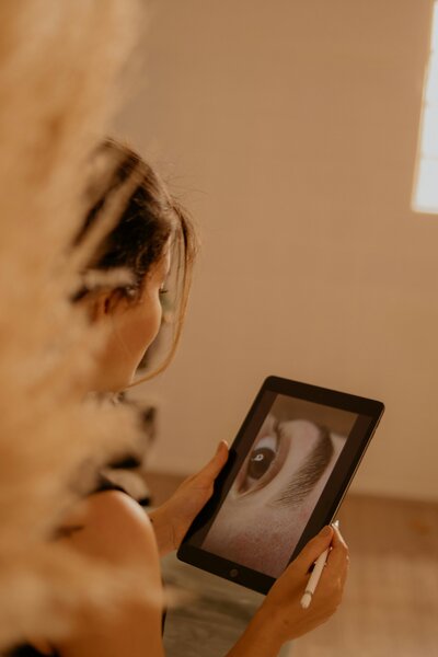 woman looking at a picture of an eye