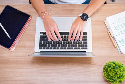 Visual Branding Audit - A woman is sitting and working on her laptop.