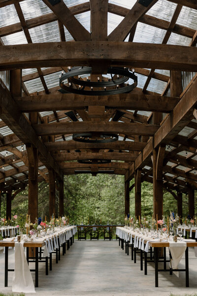 Large outdoor timber structure surrounded by nature, The Valley Weddings, a rustic and majestic wedding venue in Westerose, Alberta, featured on the Brontë Bride Vendor Guide.