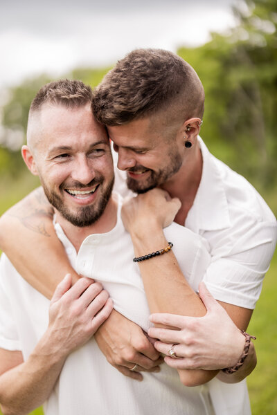 Ryan and Drew, the talented photographers and business owners of Love Always, share a joyful embrace in this heartfelt portrait. Their love, laughter, and connection shine through in this intimate outdoor moment, reflecting the passion behind their work in capturing timeless love stories.