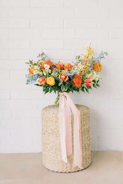 Vibrant bouquet with coral dahlias and yellow garden roses by Kendra’s Events in Granbury.