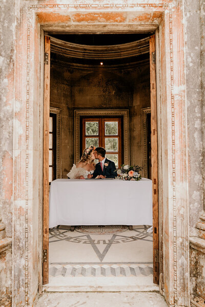 Bride and groom in roman temple on wedding day