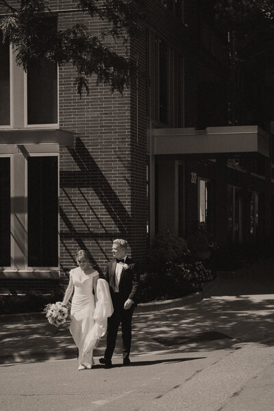 Bride and Groom walking across the street from the Minneapolis Event Center