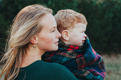 Mom and son from the side posing during family mini session photoshoot.