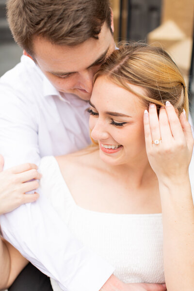 man sitting with his arms wrapped around his fiance