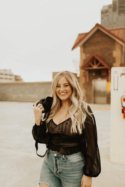 North Carolina photographer holding her camera