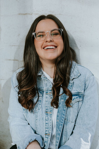 Kirsten, founder of KP Virtual Assistance, smiling warmly in a denim jacket, featured on the homepage to represent her approachable and supportive virtual assistant services for photographers