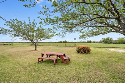 Enjoy a picnic in the large yard overlooking vast countryside at this 3-bedroom, 2.5 bathroom rural vacation rental house just minutes outside of downtown Waco, TX.