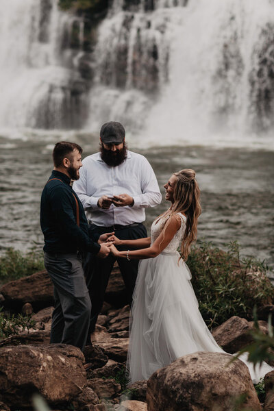 Wedding ceremony in front of Twin Falls in Rock Island State Park at their Tennessee elopement