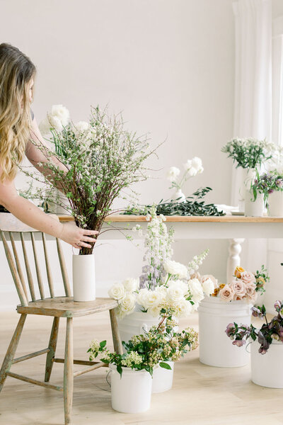 woman placing florals on table