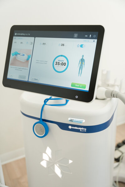 A professional at a Dallas CoolSculpting service clinic providing a consultation to a client, discussing personalized treatment options in a modern and welcoming environment.