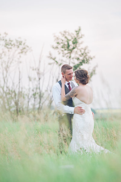 wedding couple standing in a open field