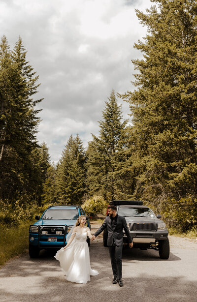 bride and groom walking in front of their trucks by washington elopement photographer