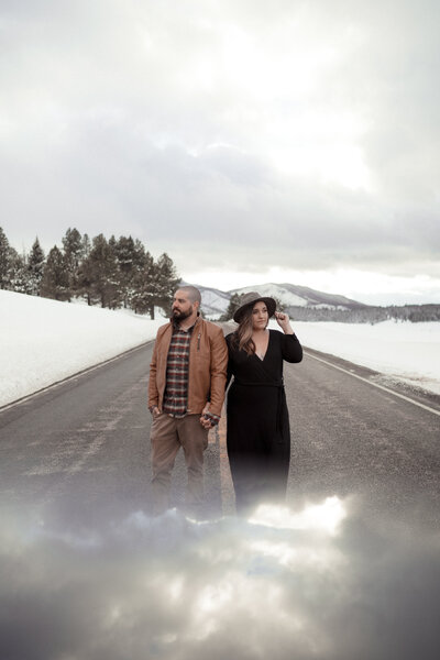 couple holding hands in road