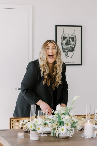 Carissa laughing while setting a tablescape