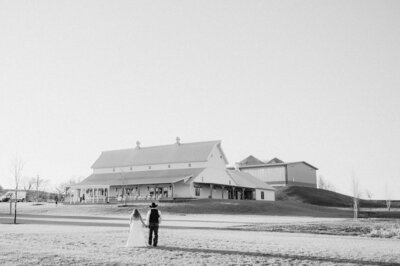 Bride and Groom walk toward The Palace Event Center in Treynor Iowa - a wedding venue near Omaha