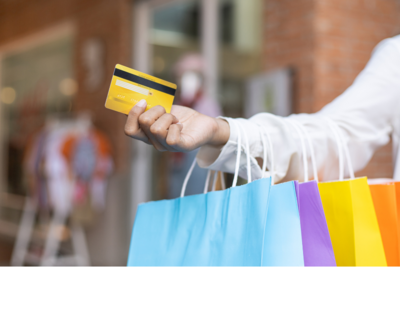 Person holding shopping bags and credit card at a Yarmouth, NS mall

