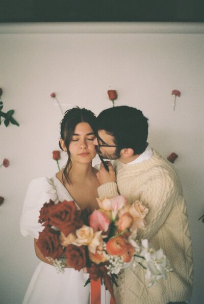film photo of bride and groom holding the bouque