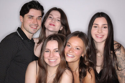 Three friends posing for a portrait photo booth print strip