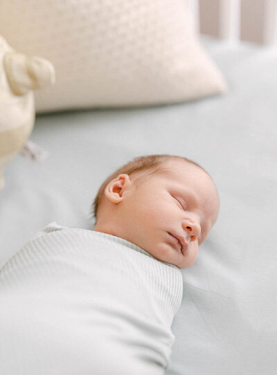 swaddled newborn laying in crib sleeping knoxville tennessee newborn photographer